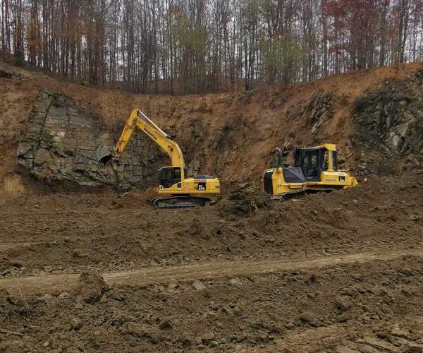 Bager i buldozer u šumi 